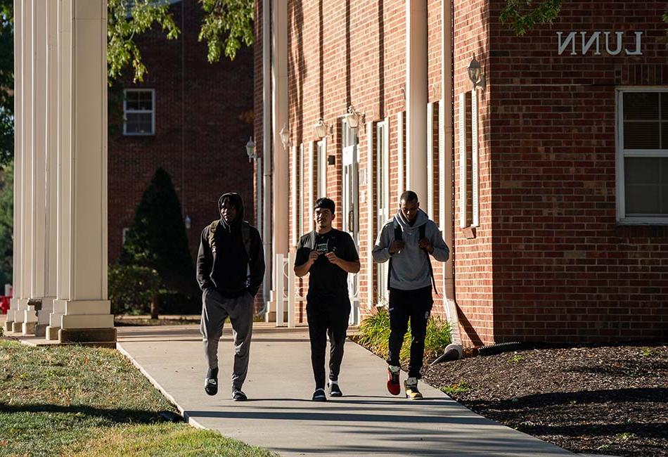 students walking on sidewalk by Lunn Hall